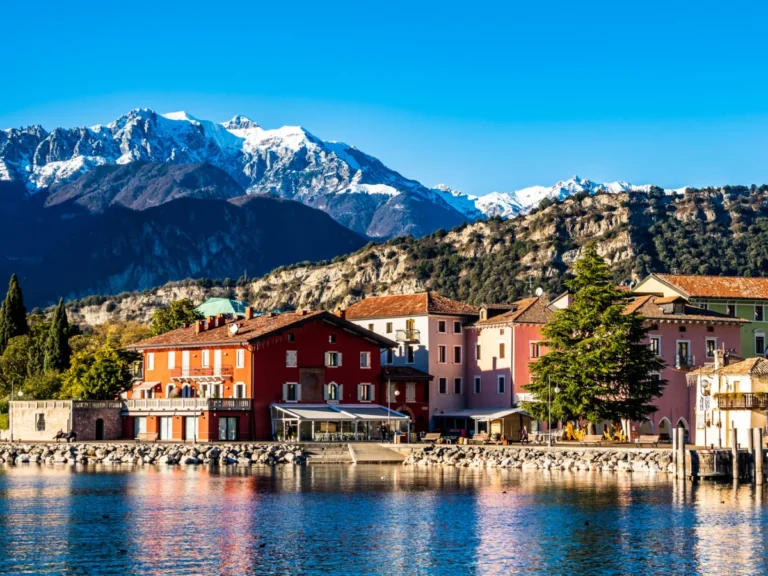 Old town and port of Torbole with views of the alps